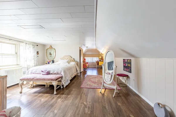 a bed room with a bed and a chair