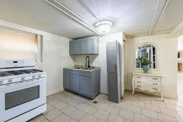 a kitchen with a sink stove top oven and cabinets