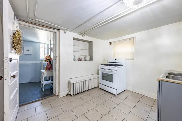a view of a hallway with furniture and a window