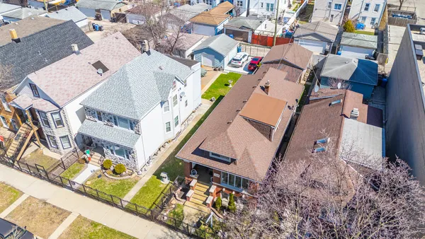 an aerial view of a house with a yard and staircase