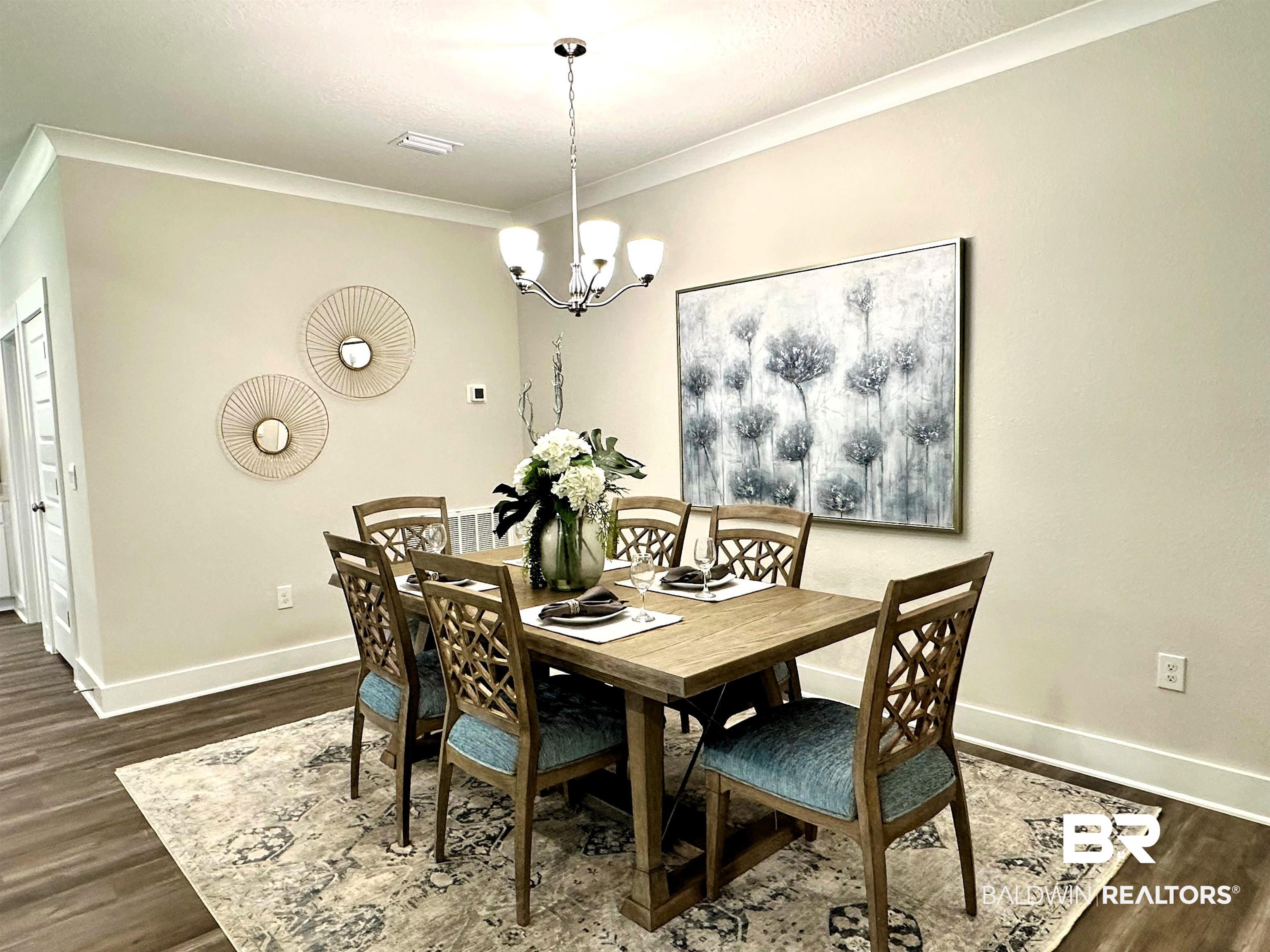 370 Barndling Street Fairhope, AL 36532 - Photo 16 of 30 Dining room with crown molding, hardwood / wood-style flooring, and a notable chandelier
