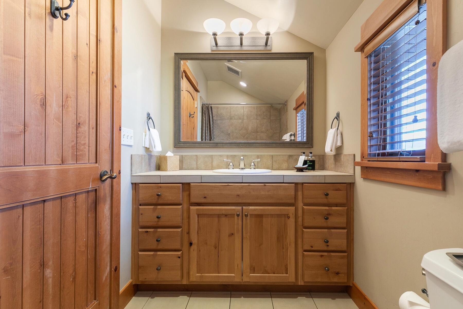 12368 Frontier Trail, Unit F2911 Truckee, CA 96161 - Photo 20 of 28 a bathroom with a sink a toilet and a mirror