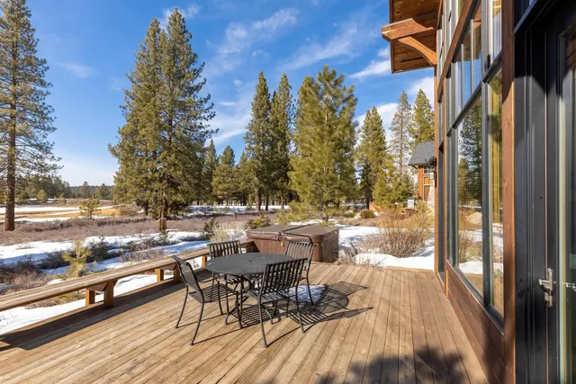 a view of a patio with dining table and chairs with wooden floor