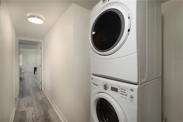 a view of a hallway with washer and dryer