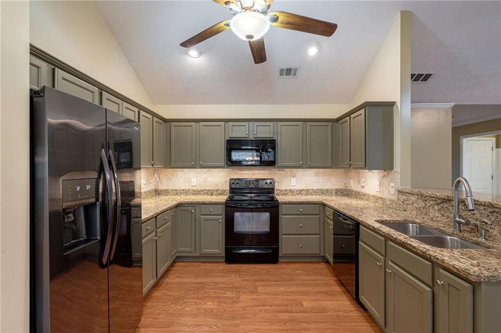 245 Memory Lane Winder, GA 30680 - Photo 16 of 62 a kitchen with stainless steel appliances granite countertop a stove and a refrigerator