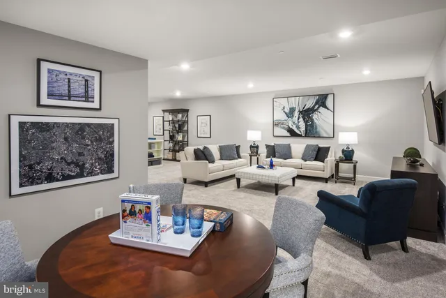 a living room with furniture and painting on the wall