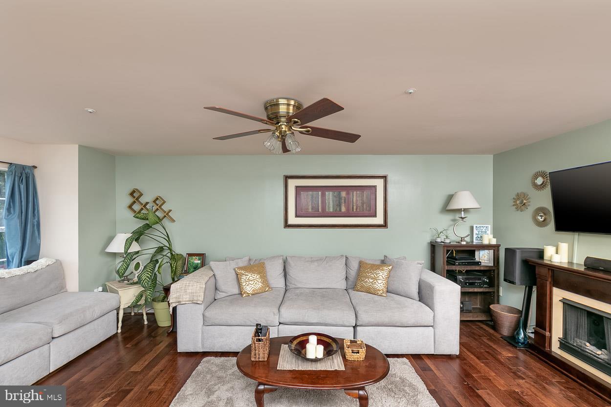 3504 Corn Stream Road Randallstown, MD 21133 - Photo 6 of 34 a living room with furniture and a flat screen tv with wooden floor