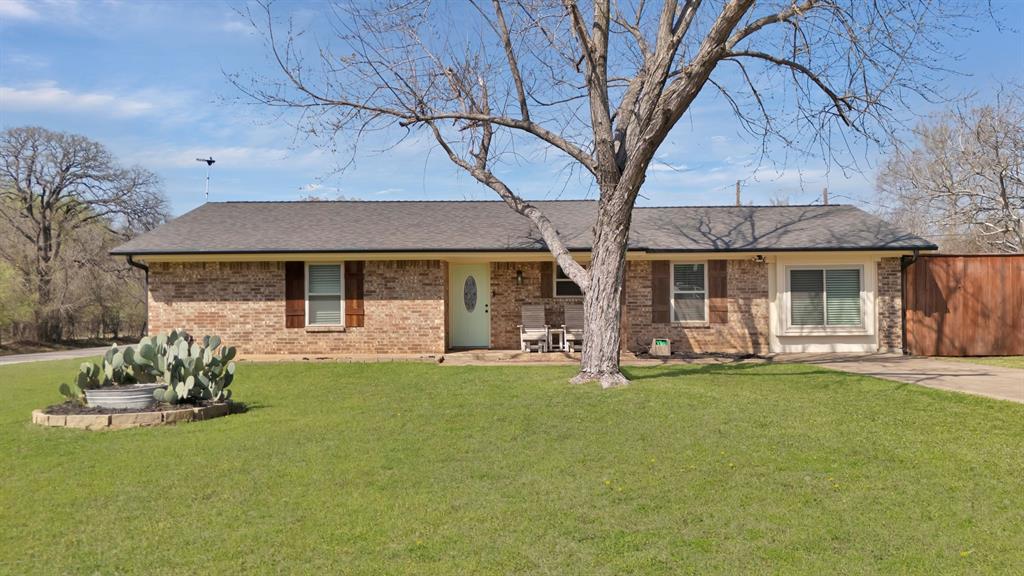 260 Gordon Drive Azle, TX 76020 - Photo 1 of 1 Ranch-style home with brick siding, a shingled roof, a front lawn, and fence