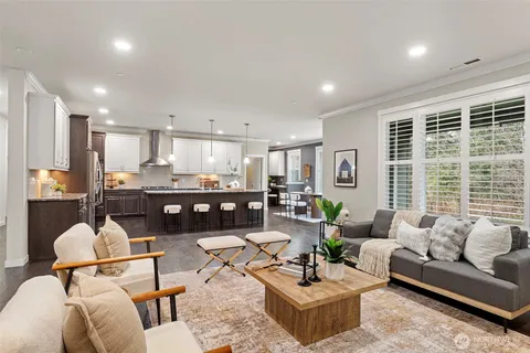 a living room with furniture and kitchen view