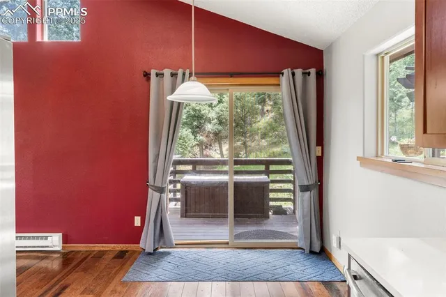 a view of a room with a window and wooden floor