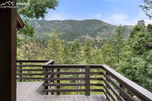 a view of balcony with wooden floor and fence