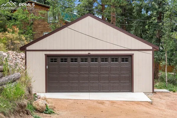 a view of house with garage and yard