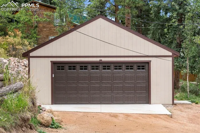 a view of house with garage and yard