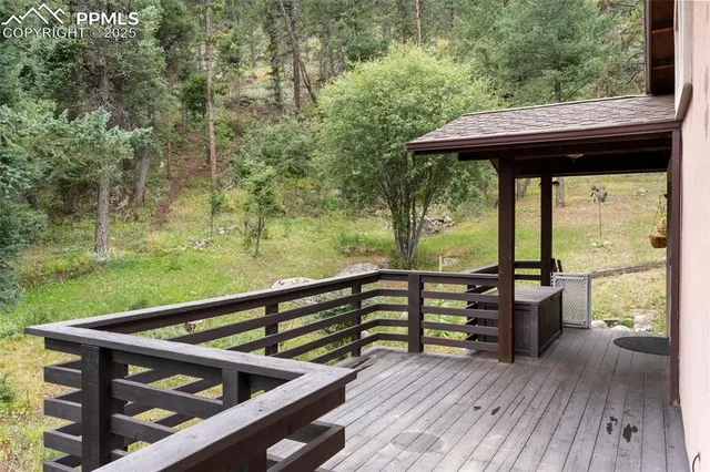 a view of a deck with wooden floor and outdoor seating