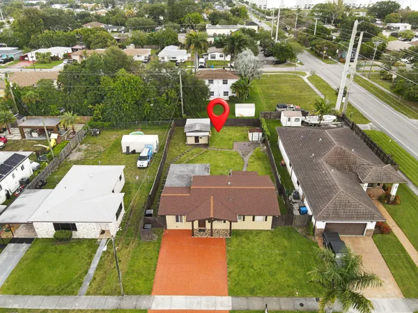 an aerial view of a pool patio yard and mountain view