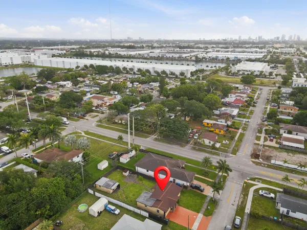 an aerial view of residential houses with outdoor space and river