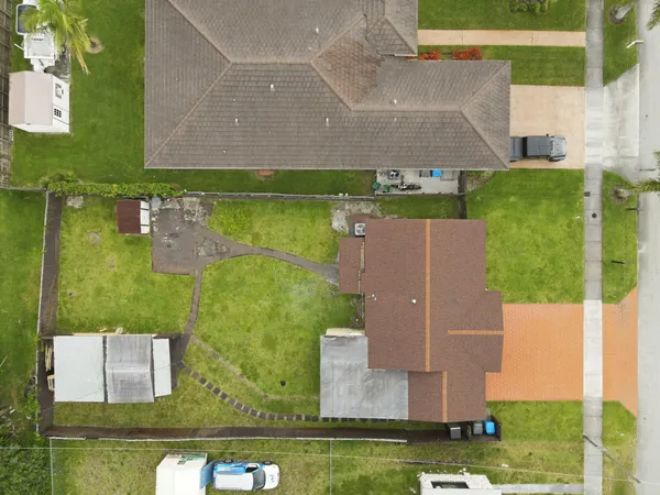 an aerial view of residential houses with outdoor space and swimming pool