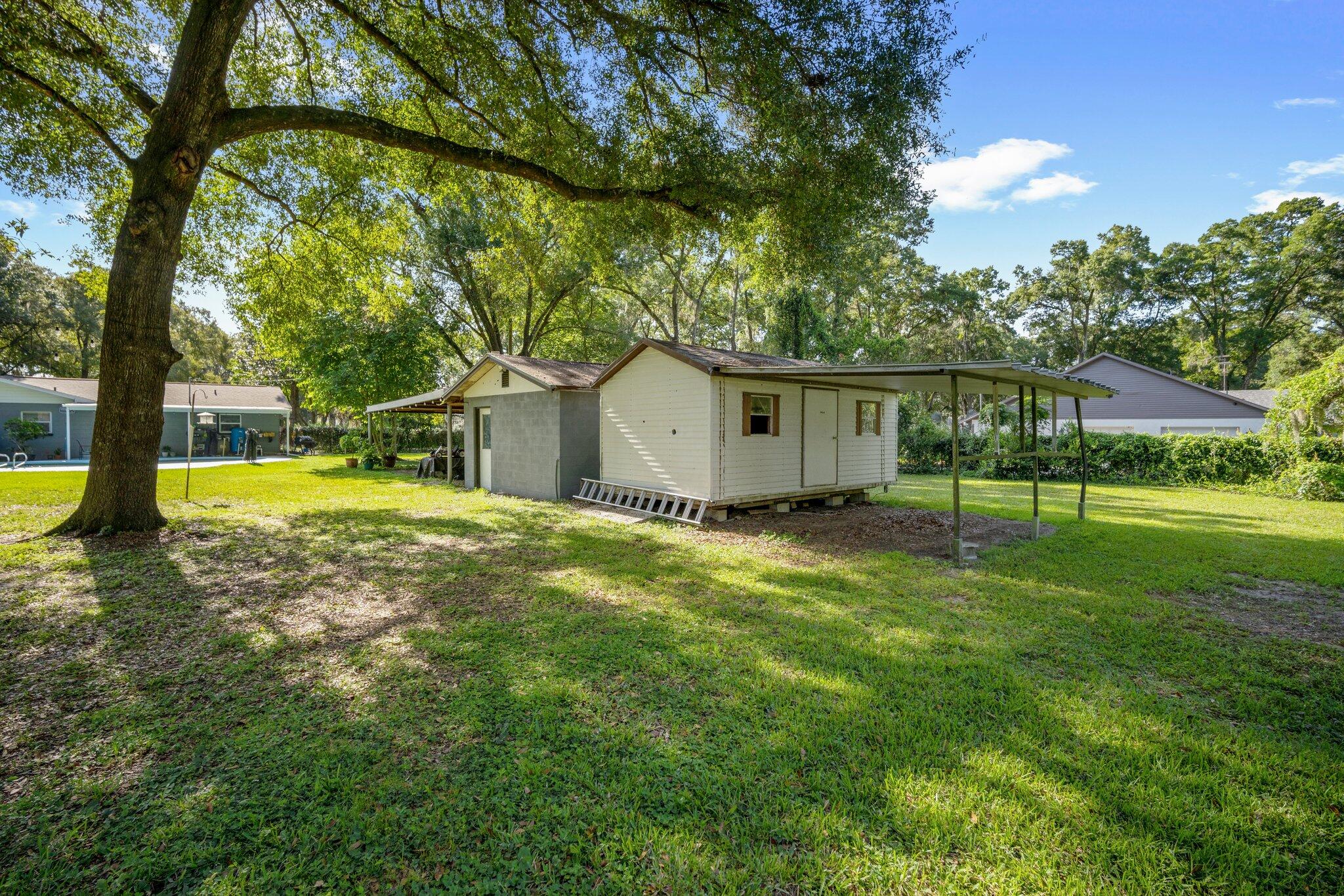3411 Ranch Road Valrico, FL 33596 - Photo 23 of 28 a view of a house with a backyard and a tree