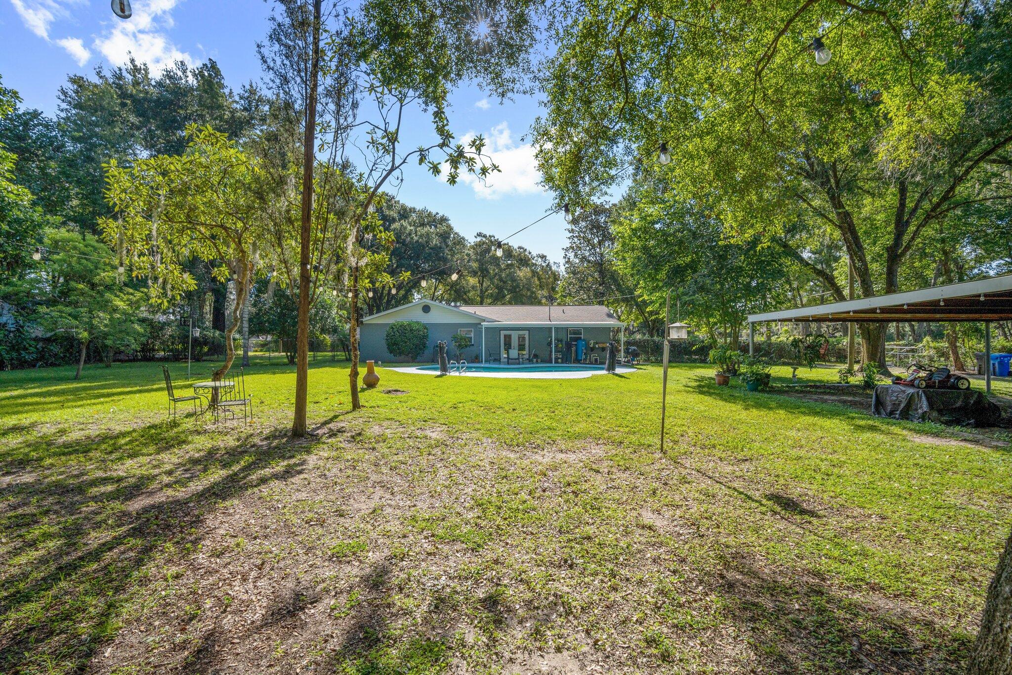 3411 Ranch Road Valrico, FL 33596 - Photo 25 of 28 a view of a house with a swimming pool