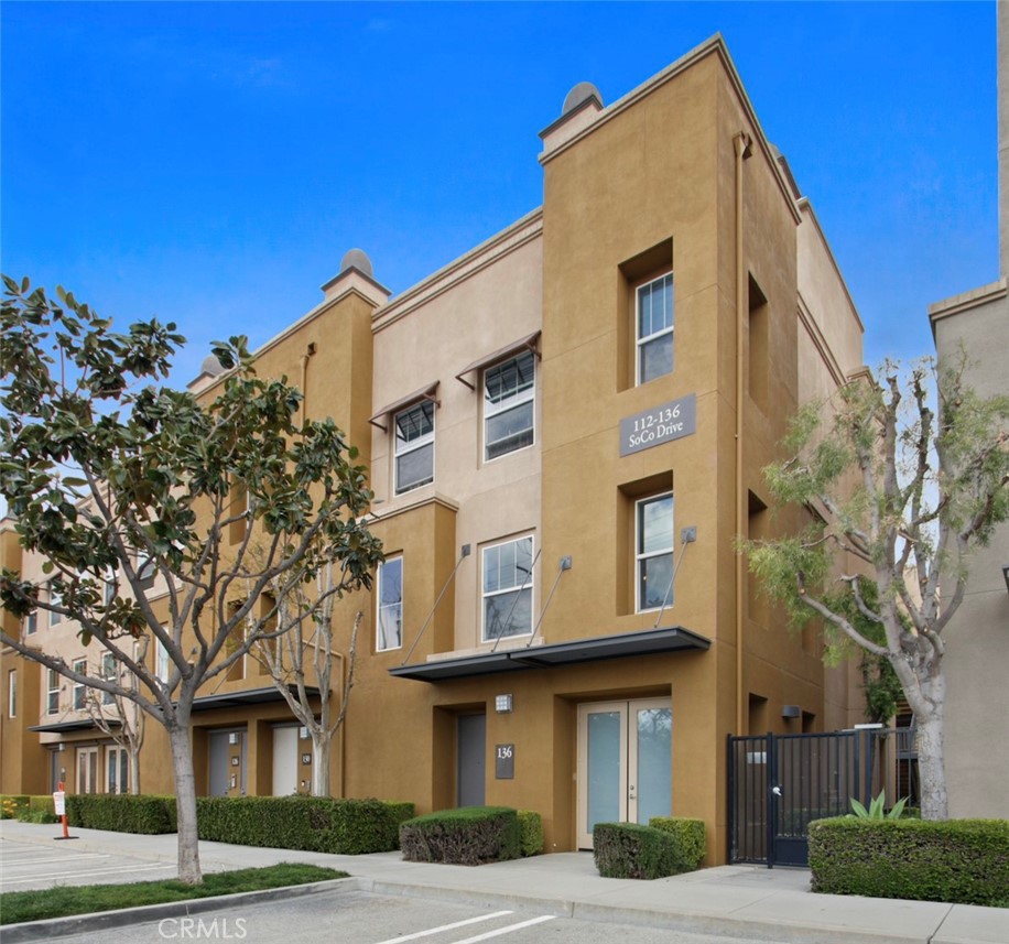 136 Soco Drive Fullerton, CA 92832 - Photo 1 of 35 a front view of a residential apartment building with a yard
