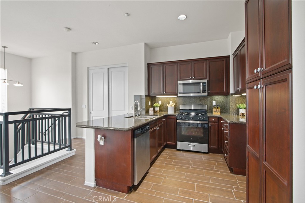 136 Soco Drive Fullerton, CA 92832 - Photo 16 of 35 a large kitchen with stainless steel appliances granite countertop a stove and a refrigerator