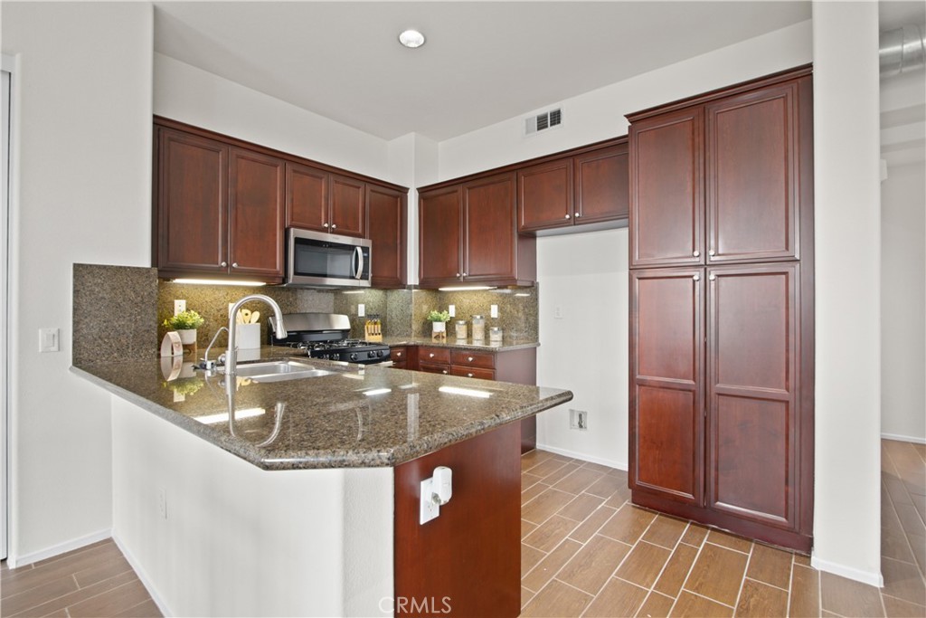 136 Soco Drive Fullerton, CA 92832 - Photo 17 of 35 a kitchen with stainless steel appliances granite countertop a refrigerator a sink a stove a microwave and cabinets