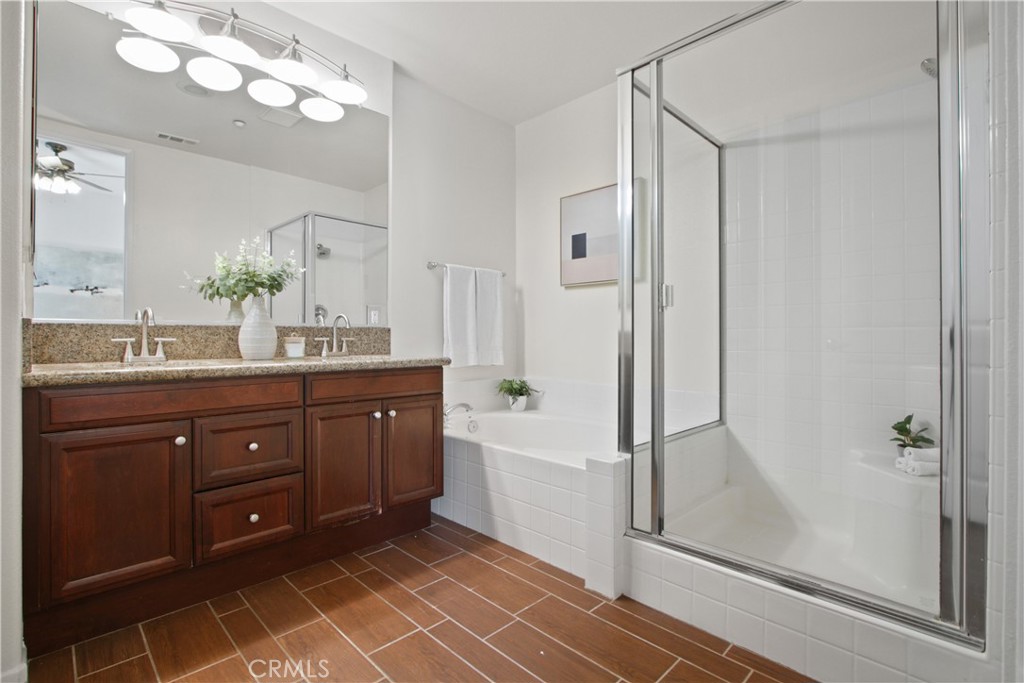 136 Soco Drive Fullerton, CA 92832 - Photo 21 of 35 a spacious bathroom with a granite countertop sink a mirror and a shower