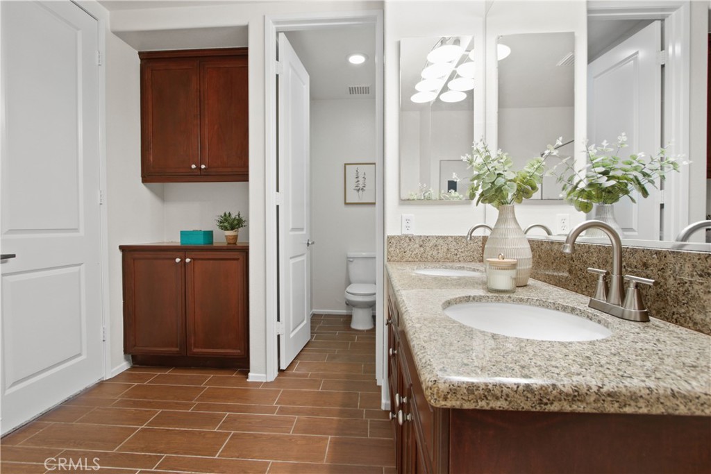 136 Soco Drive Fullerton, CA 92832 - Photo 22 of 35 a bathroom with a granite countertop sink a mirror and a shower