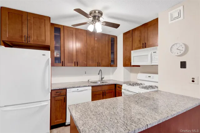 a view of a livingroom with furniture and chandelier fan