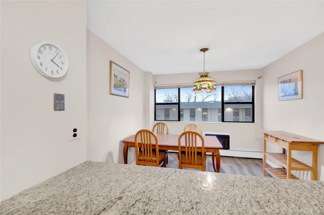 a dining room with furniture a chandelier and wooden floor