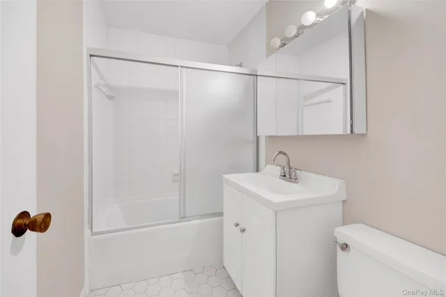 a bathroom with a sink mirror vanity and toilet