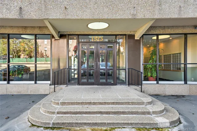 a view of lobby with floor to ceiling windows and dining table
