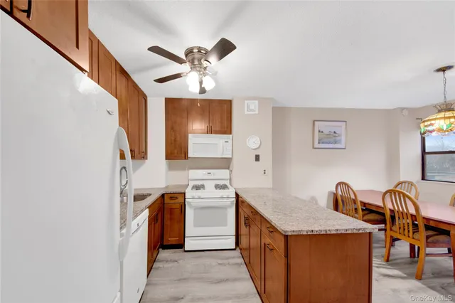 a view of kitchen and island with cabinets