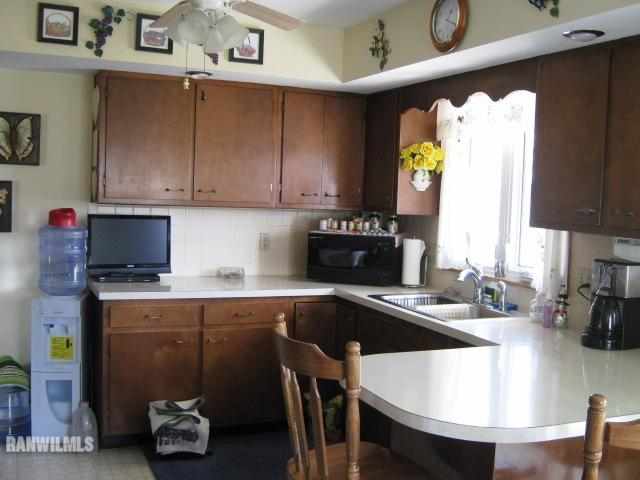 1275 South Bolton Road Freeport, IL 61032 - Photo 7 of 12 a kitchen with a table chairs sink and cabinets