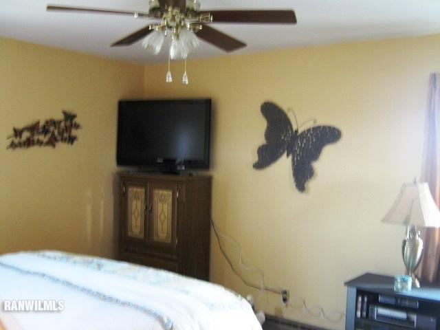 1275 South Bolton Road Freeport, IL 61032 - Photo 8 of 12 a bedroom with a bed and a chandelier