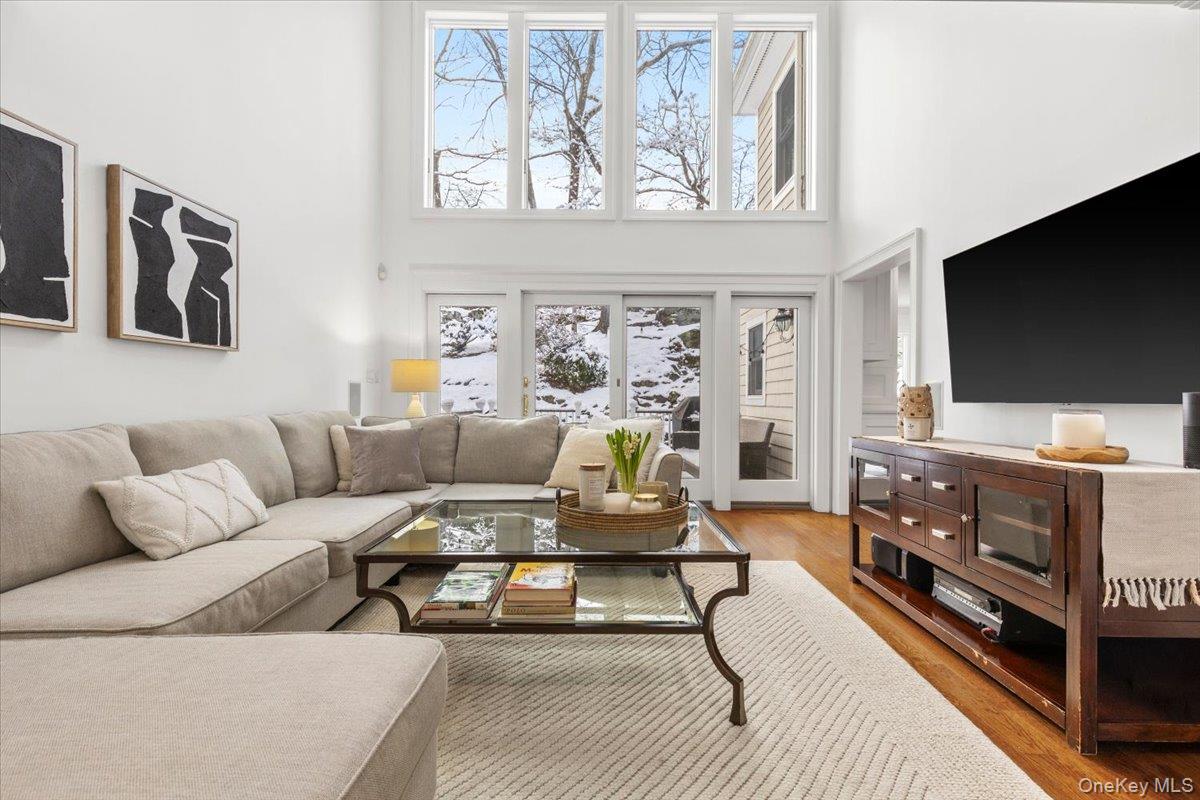 14 Eagles Bluff Rye Brook, NY 10573 - Photo 16 of 48 Great family room off the kitchen with dramatic floor to ceiling windows overlooking bucolic backyard with doors to deck