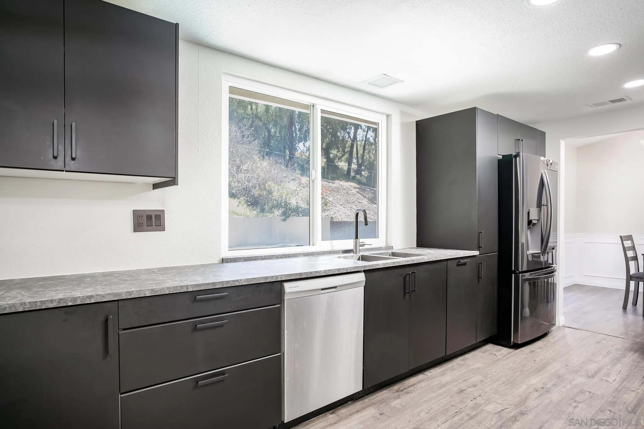 9229 Birchcrest Boulevard Santee, CA 92071 - Photo 12 of 39 a kitchen with stainless steel appliances granite countertop a refrigerator and a sink