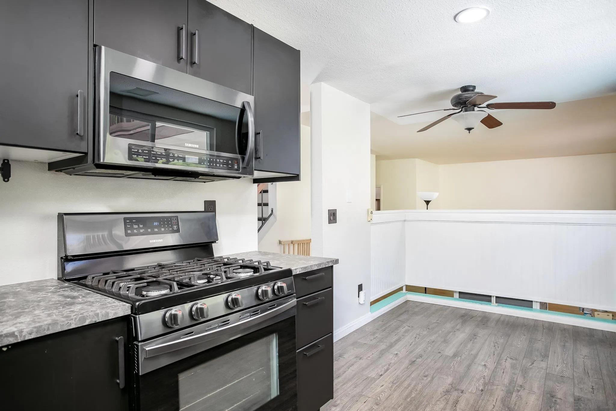 9229 Birchcrest Boulevard Santee, CA 92071 - Photo 13 of 39 a kitchen with a stove and a microwave