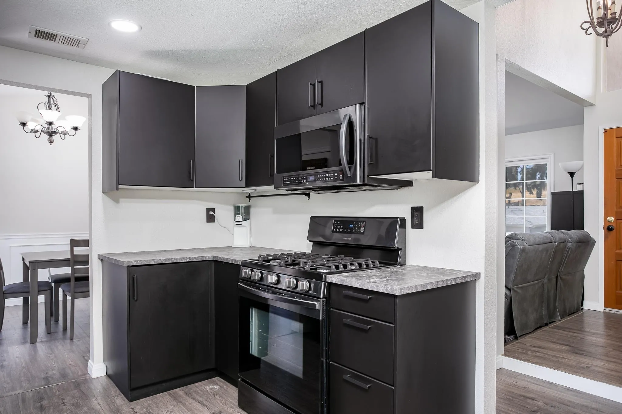 9229 Birchcrest Boulevard Santee, CA 92071 - Photo 14 of 39 a kitchen with stainless steel appliances a stove microwave and sink
