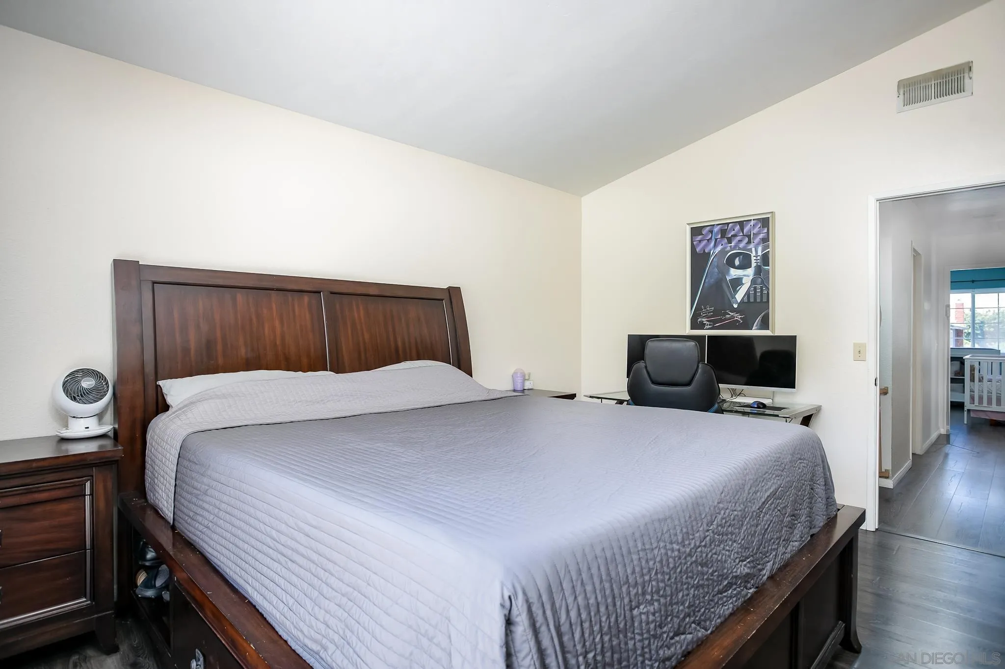 9229 Birchcrest Boulevard Santee, CA 92071 - Photo 23 of 39 a bedroom with a bed and wooden floor