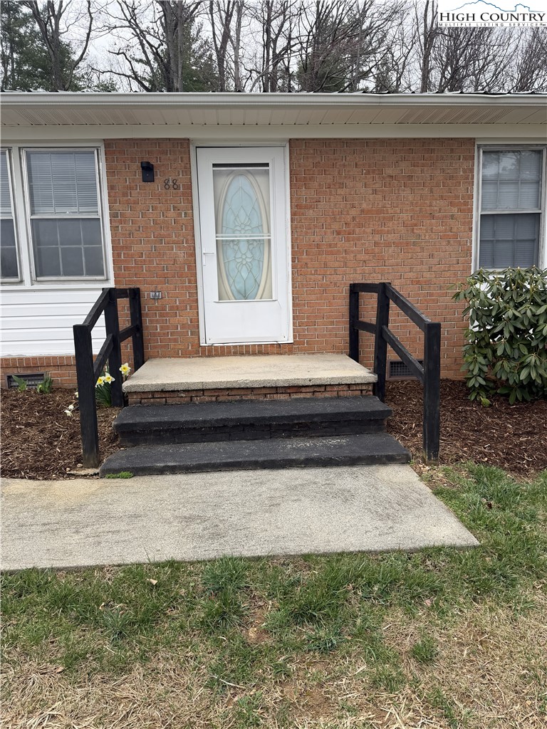 88 Grandridge Road Sparta, NC 28675 - Photo 21 of 21 a view of backyard with a chair and potted plants