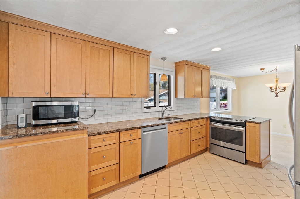 3 Ruth Drive Framingham, MA 01701 - Photo 3 of 35 a kitchen with stainless steel appliances granite countertop a stove a sink and a microwave