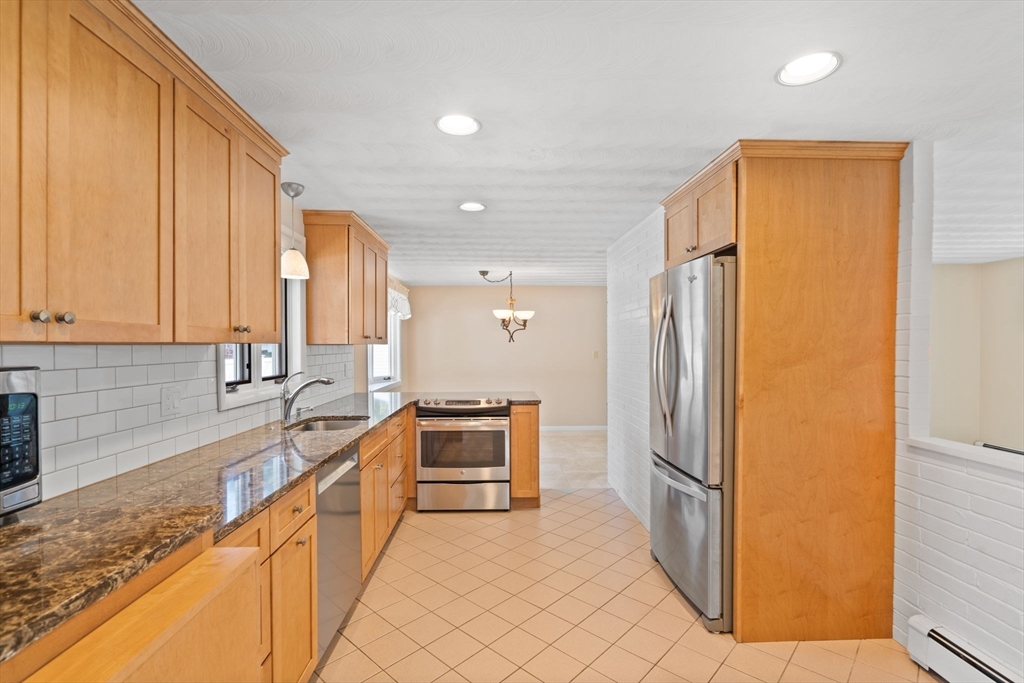 3 Ruth Drive Framingham, MA 01701 - Photo 4 of 35 a kitchen with stainless steel appliances granite countertop a refrigerator and a sink