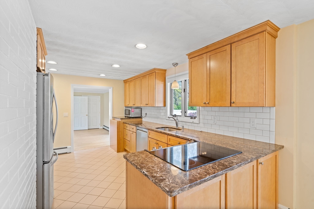 3 Ruth Drive Framingham, MA 01701 - Photo 5 of 35 a kitchen with stainless steel appliances granite countertop a sink and a refrigerator
