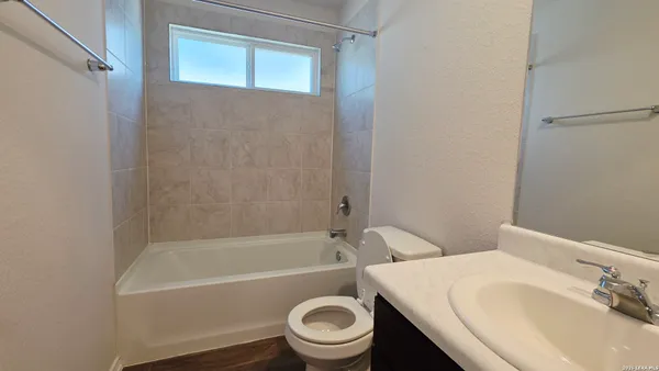 a bathroom with a sink a toilet and a bathtub