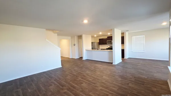 a view of a kitchen with a sink and a refrigerator