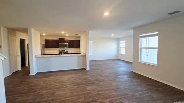 a view of kitchen with kitchen island wooden floor and center island