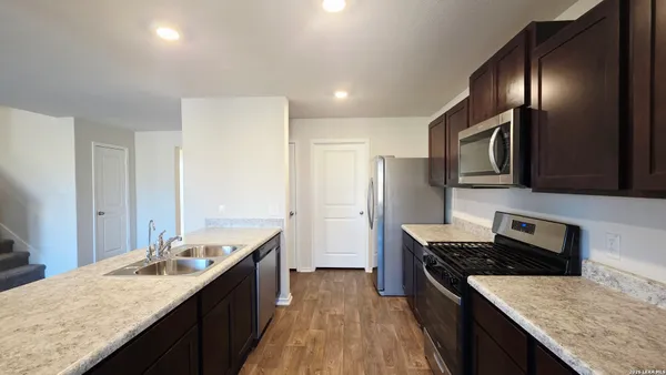 a kitchen with granite countertop counter space a sink and stainless steel appliances