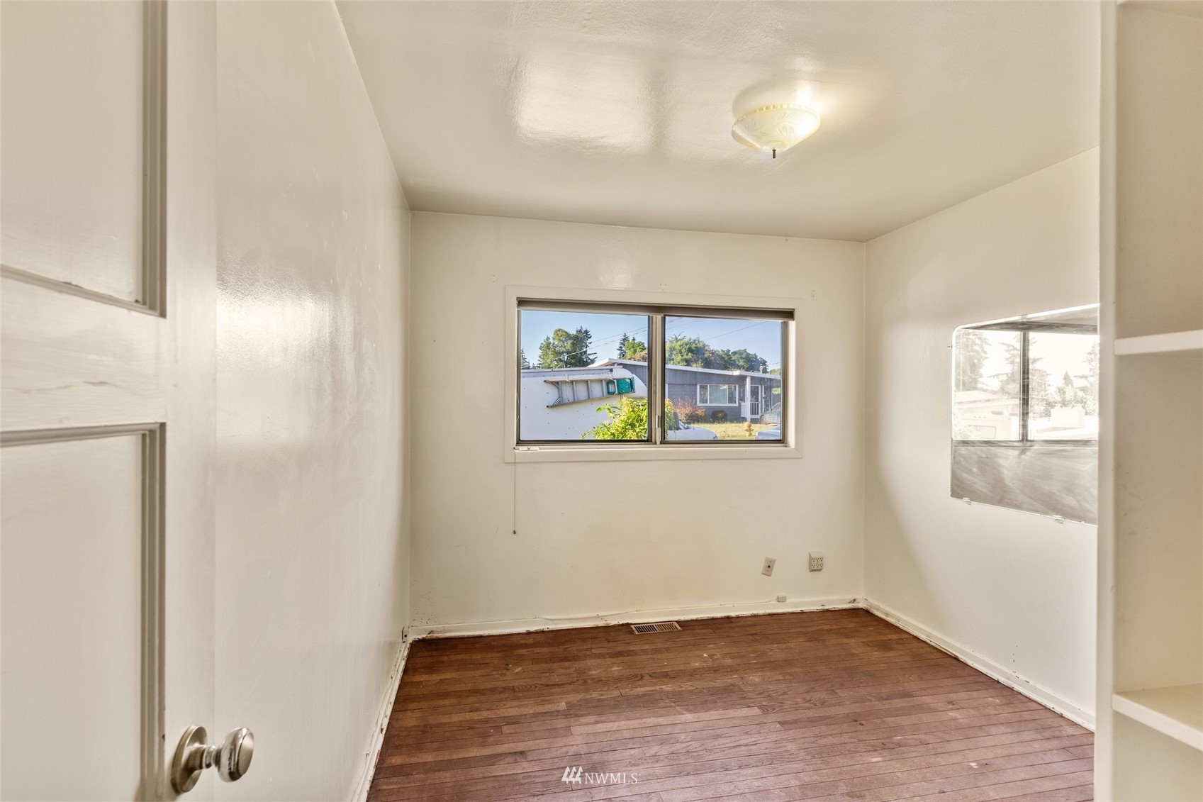 2309 Northeast 9th Street Renton, WA 98056 - Photo 11 of 22 an empty room with windows and entrance