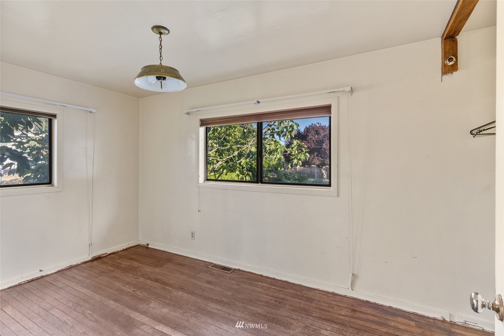 2309 Northeast 9th Street Renton, WA 98056 - Photo 13 of 22 a view of an empty room with a window and wooden floor
